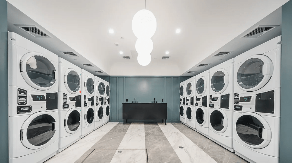 a washer and dryer room with a bunch of washing machines in it